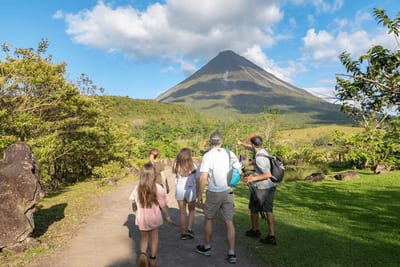 Family with a tour guide exploring the area near Arenal Volcano in Costa Rica, enjoying a guided nature experience.