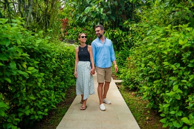 A couple walks a rainforest boardwalk in the Ecuadorian Amazon.