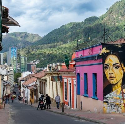 A colorful street with murals in Bogotá's La Candelaria district, Colombia.