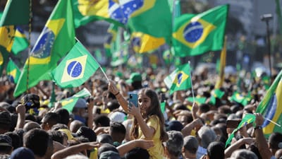 Crowd raising green-and-yellow Brazilian flags during a September 7 independence celebration