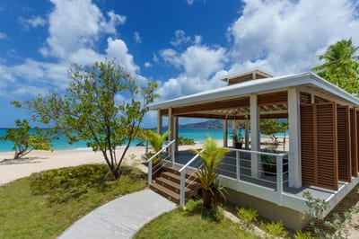 A resort infinity pool spills toward the Caribbean Sea.