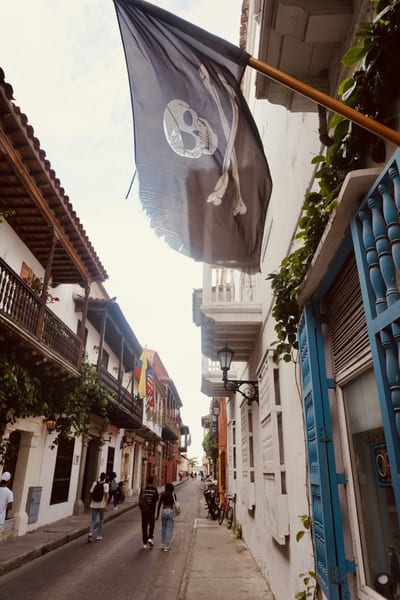 A colorful colonial street with flowered balconies in Cartagena's walled old town, Colombia.