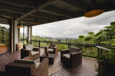 A lodge terrace overlooking green Andean coffee hills, Colombia.