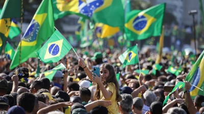 A crowd waving Brazilian flags during an independence-day celebration in Latin America