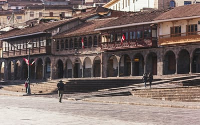 Colonial stone arcades line the main square of Cusco, Peru.
