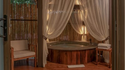 The private outdoor jacuzzi with drawn curtains on a Deluxe Suite deck at El Silencio Lodge, Bajos del Toro, Costa Rica