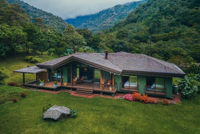 The modern three-bedroom villa at El Silencio Lodge with cloud forest mountains rising behind, Bajos del Toro, Costa Rica