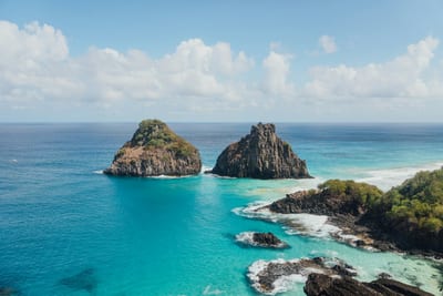 The Dois Irmãos twin rocks in turquoise water at Fernando de Noronha, Brazil.