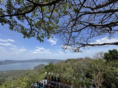 The turquoise caldera of Lake Coatepeque viewed from its forested rim, a volcanic crater lake in western El Salvador.