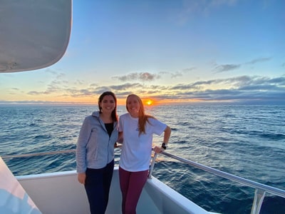 Melanie and Kathleen, co-founders of Explore the Americas, at sunset aboard a boat in the Galápagos