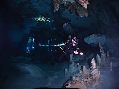 Diver descending into a cenote cave in the Yucatán