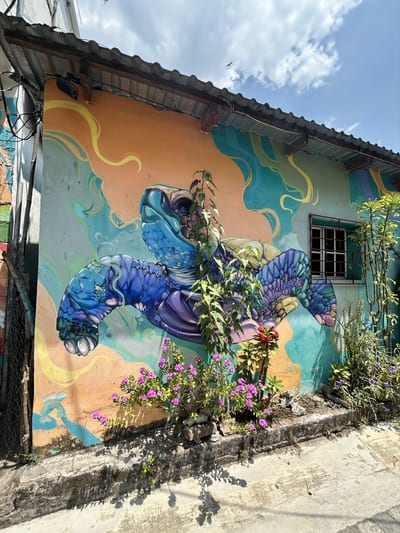 A vivid street mural brightens a colonial coffee town on El Salvador's Ruta de las Flores.