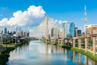 The São Paulo skyline and the Octávio Frias bridge along the Pinheiros river, Brazil.