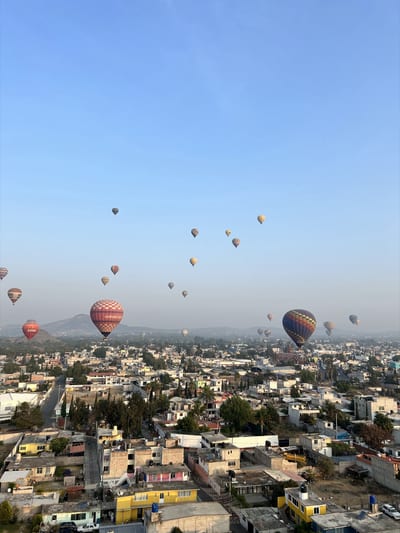 Hot-air balloons rise over the pyramids of Teotihuacán at sunrise near Mexico City.