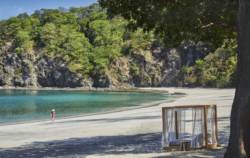 Secluded white-sand beach with turquoise water and a luxury cabana on the Papagayo Peninsula in Guanacaste, Costa Rica.