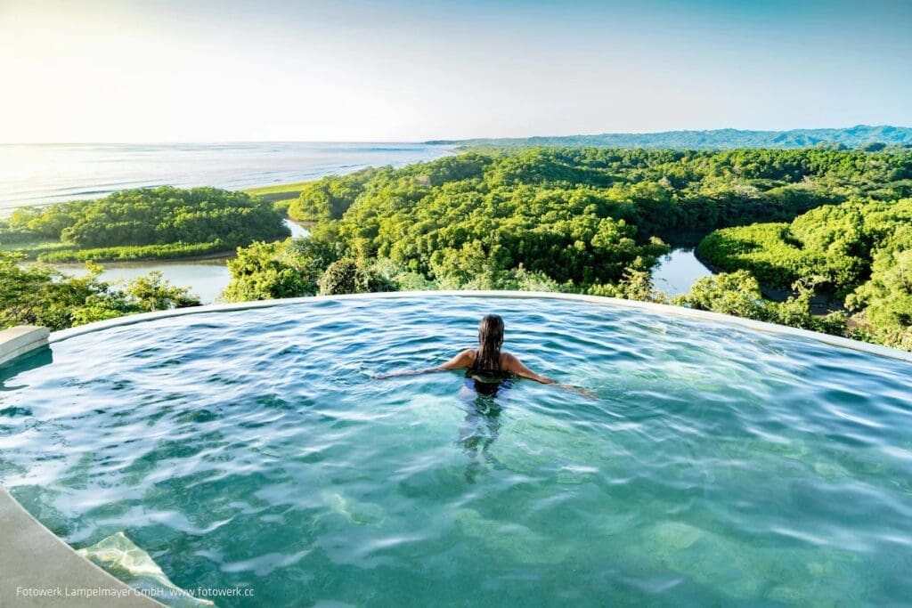 Infinity pool overlooking mangroves and ocean at Lagarta Lodge Nosara Costa Rica