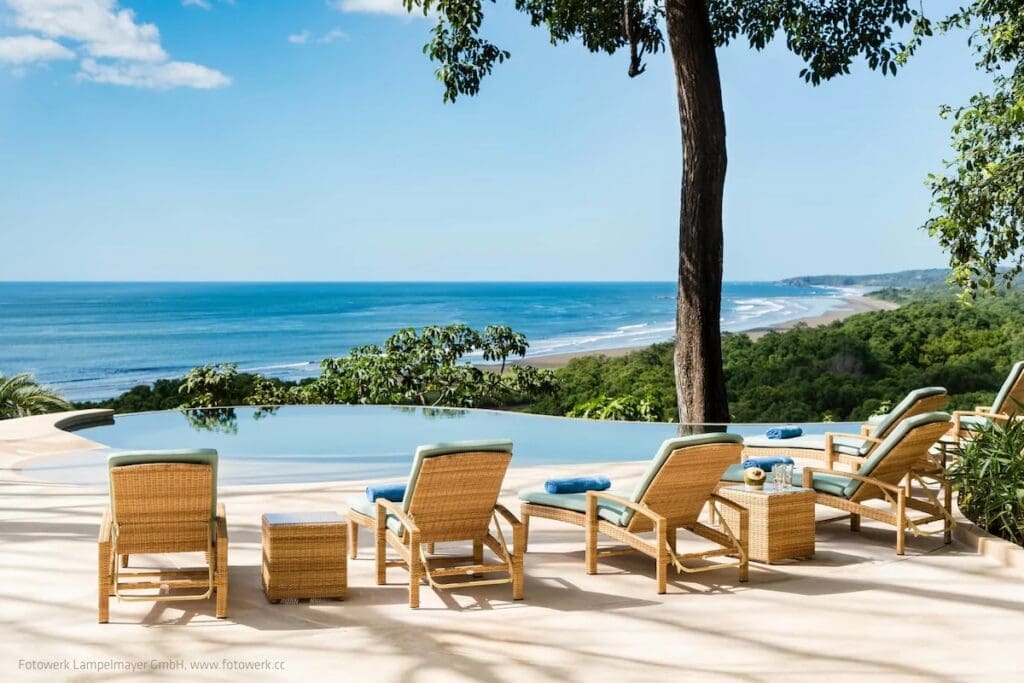 Pool deck and loungers overlooking the ocean at Lagarta Lodge Nosara Costa Rica